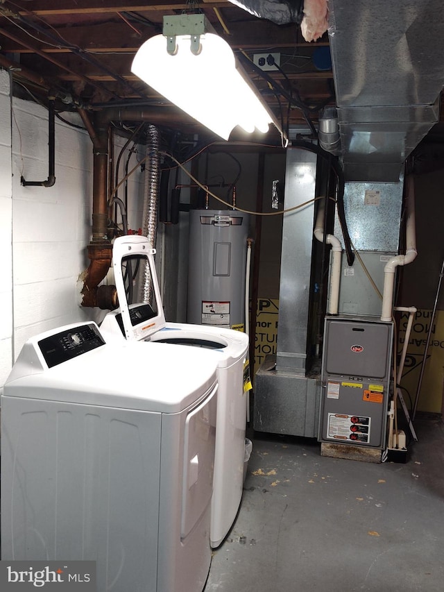 laundry area featuring concrete block wall, water heater, laundry area, and independent washer and dryer