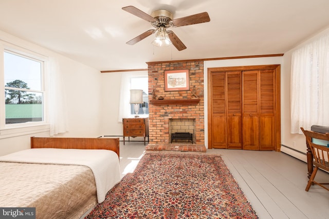 100 Wall St, Queenstown, MD 21658 - bedroom featuring crown molding, hardwood / wood-style floors, a ceiling fan, a closet, and baseboard heating