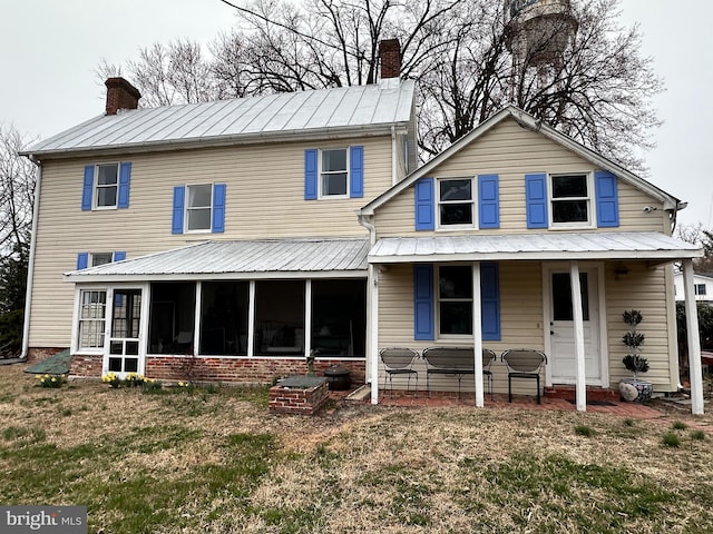 100 Wall St, Queenstown, MD 21658 - rear view of house featuring a chimney, a sunroom, and brick siding