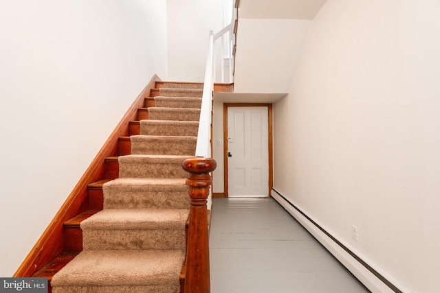 100 Wall St, Queenstown, MD 21658 - staircase featuring a baseboard radiator, wood finished floors, and baseboards