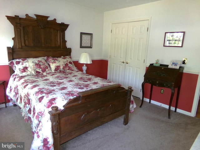 bedroom with carpet, a closet, and baseboards