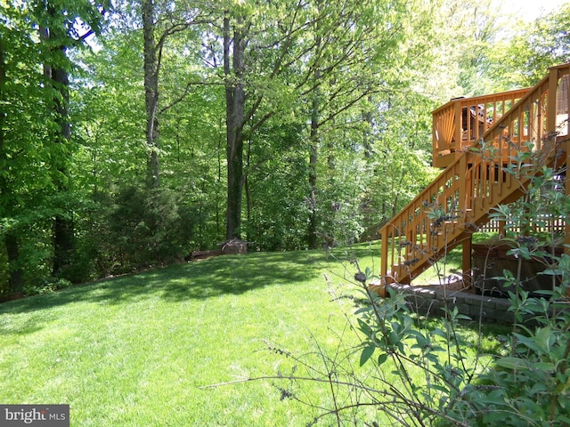 view of yard with stairway and a deck
