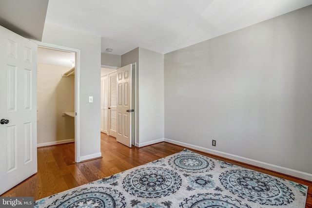 bedroom with baseboards and wood finished floors