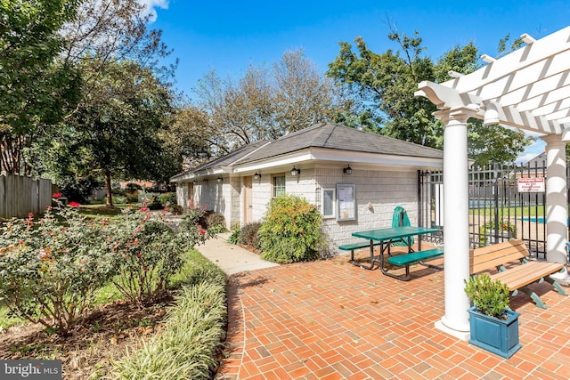 view of patio / terrace featuring a pergola and fence