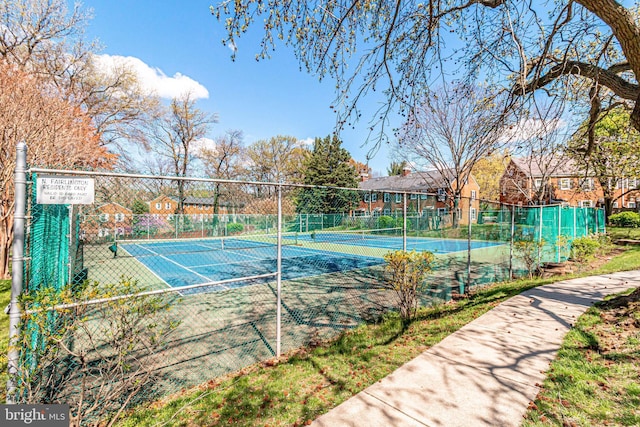 view of sport court featuring fence