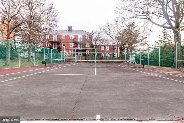 view of tennis court featuring fence