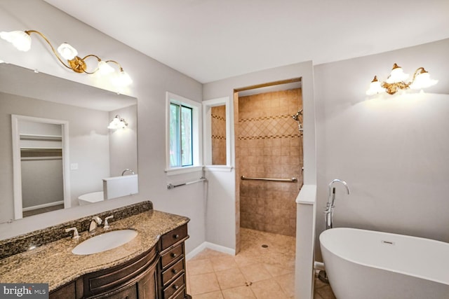 8012 Exodus Dr, Gaithersburg, MD 20882 - full bathroom with walk in shower, a freestanding bath, vanity, baseboards, and tile patterned flooring