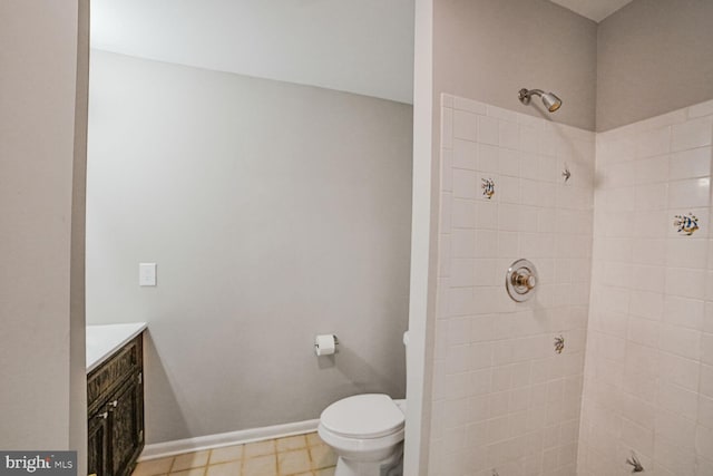 8012 Exodus Dr, Gaithersburg, MD 20882 - bathroom featuring a tile shower, toilet, vanity, and baseboards