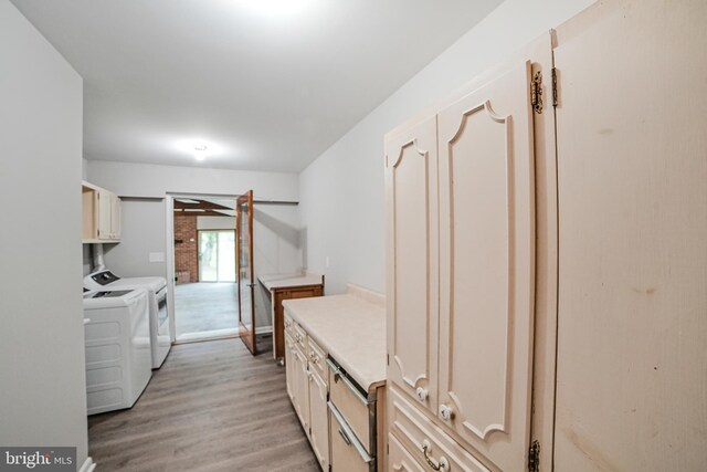 8012 Exodus Dr, Gaithersburg, MD 20882 - clothes washing area with washing machine and clothes dryer, cabinet space, and light wood-type flooring