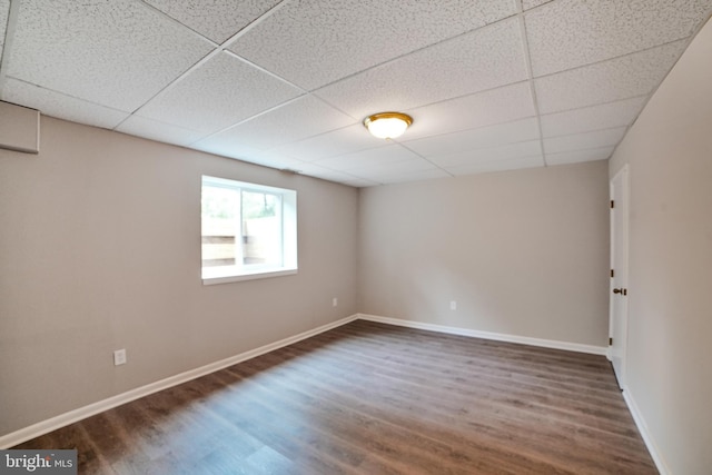 8012 Exodus Dr, Gaithersburg, MD 20882 - empty room with dark wood-style floors, a paneled ceiling, and baseboards