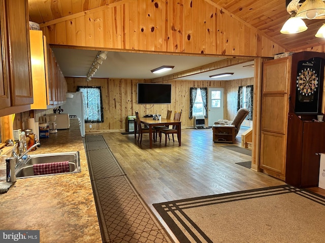 385 Elk Crk, Aaronsburg, PA 16820 - kitchen with lofted ceiling, a sink, light wood-style floors, and wooden walls