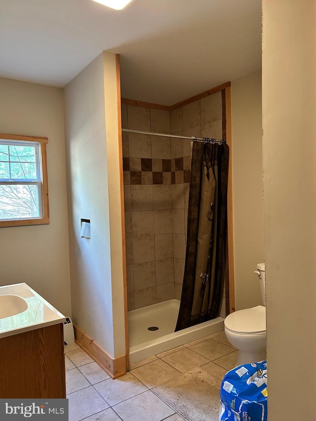 385 Elk Crk, Aaronsburg, PA 16820 - bathroom with tile patterned flooring, vanity, toilet, baseboards, and a stall shower