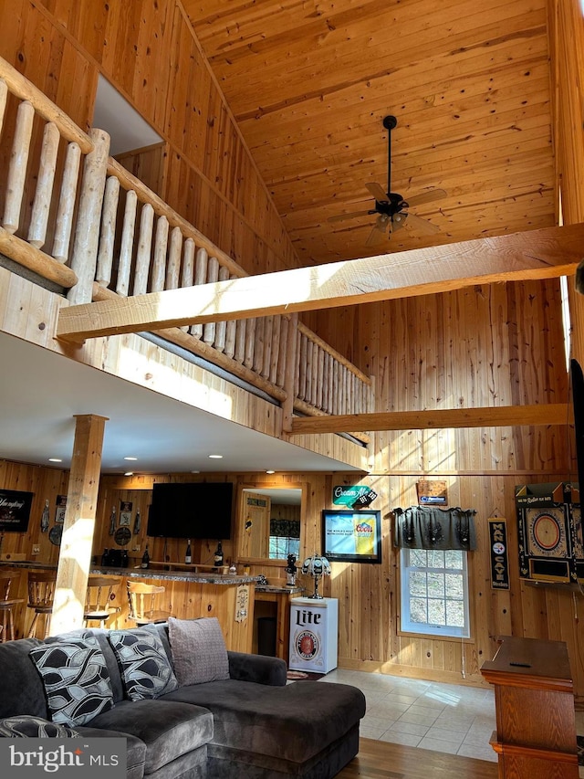385 Elk Crk, Aaronsburg, PA 16820 - tiled living area with a ceiling fan, a towering ceiling, and wood walls