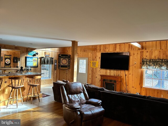 385 Elk Crk, Aaronsburg, PA 16820 - living room with a fireplace, wood walls, and a healthy amount of sunlight