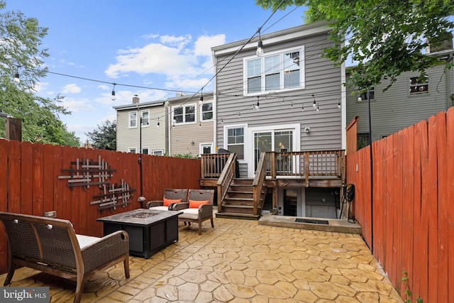 205 16th St SE, Washington, DC 20003 - back of house featuring a wooden deck, a patio area, a fenced backyard, and an outdoor living space with a fire pit