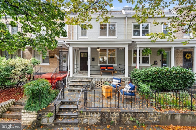 205 16th St SE, Washington, DC 20003 - view of front of property featuring brick siding, a ceiling fan, and a porch