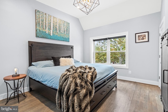 205 16th St SE, Washington, DC 20003 - bedroom with vaulted ceiling, wood finished floors, and a chandelier