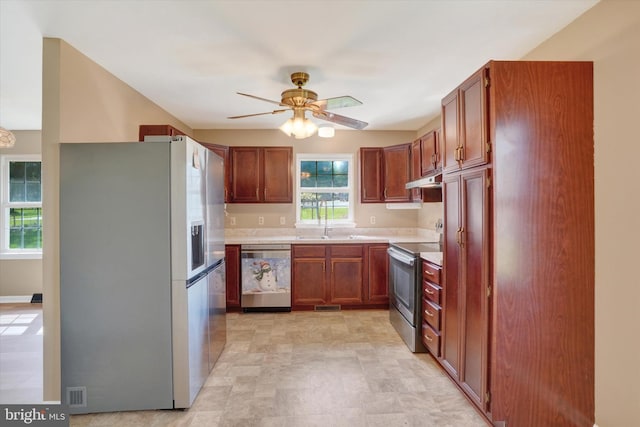 kitchen featuring visible vents, a ceiling fan, light countertops, and stainless steel appliances