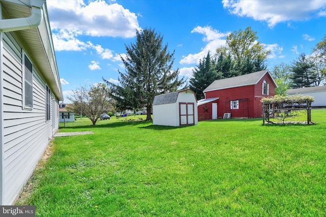 view of yard with a storage unit and an outbuilding