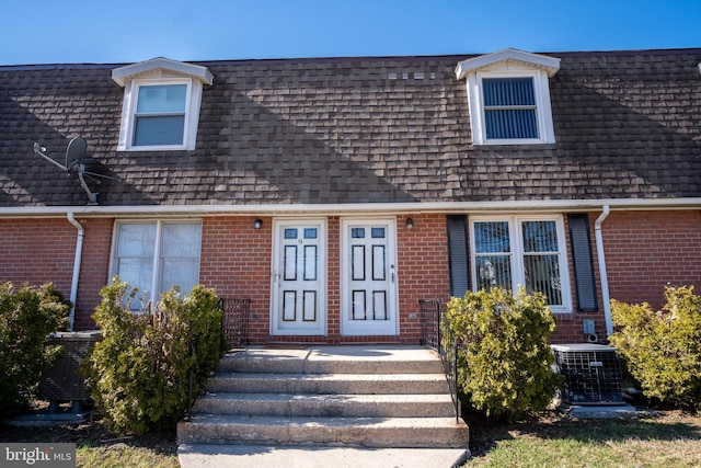 216 Shaw St Unit A10, Frostburg, MD 21532 - entrance to property featuring mansard roof, brick siding, central AC, and a shingled roof