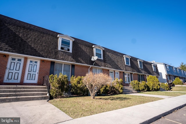 216 Shaw St Unit A10, Frostburg, MD 21532 - view of front of property with brick siding, a residential view, a shingled roof, and a front lawn