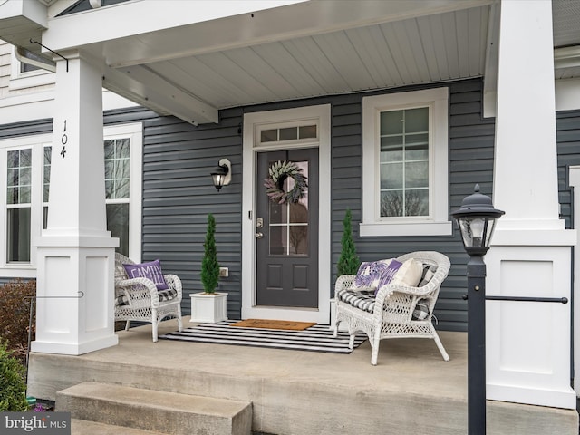 view of exterior entry with a porch