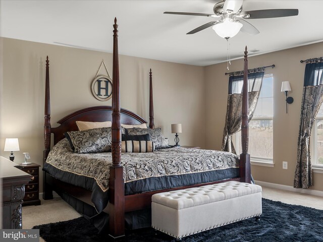 bedroom featuring baseboards, carpet flooring, and a ceiling fan
