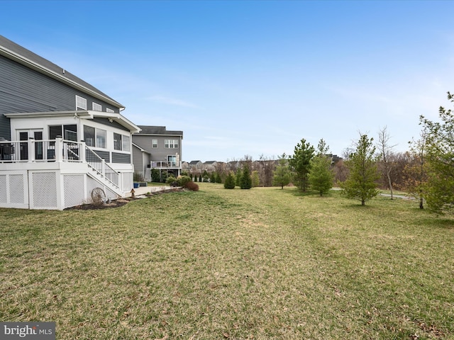 view of yard featuring a sunroom and stairs