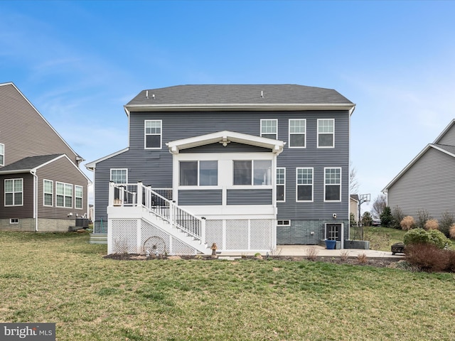 back of house featuring stairs, cooling unit, a sunroom, a patio, and a lawn