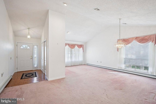 carpeted entrance foyer with an inviting chandelier, a textured ceiling, a baseboard heating unit, and visible vents