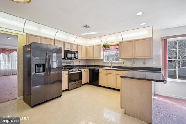 kitchen with visible vents, light carpet, light brown cabinets, a sink, and black appliances