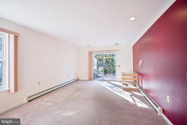 carpeted spare room featuring recessed lighting and baseboard heating
