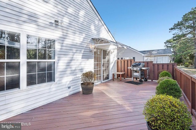 wooden terrace featuring fence and grilling area