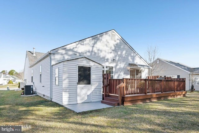 rear view of property with a lawn, central air condition unit, and a wooden deck