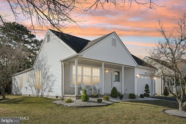 view of front facade featuring a lawn, an attached garage, covered porch, and crawl space