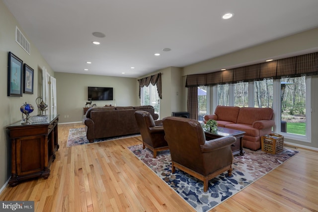 living room with baseboards, recessed lighting, visible vents, and light wood-type flooring