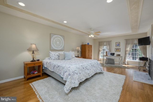 bedroom with baseboards, recessed lighting, and a tray ceiling