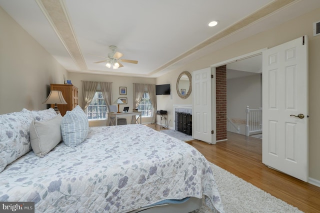 bedroom with visible vents, recessed lighting, a ceiling fan, wood finished floors, and a raised ceiling