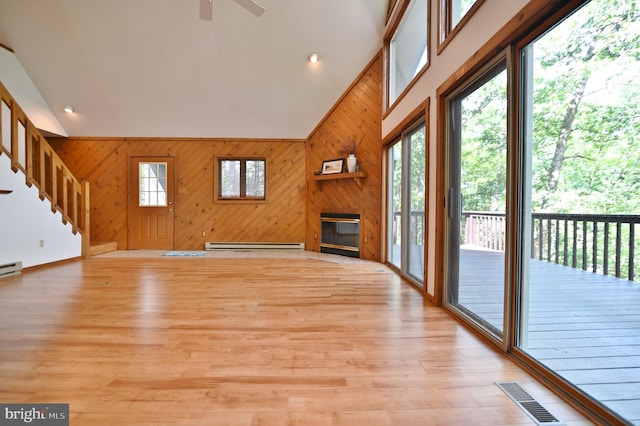 277 Anderson Rd, Basye, VA 22810 - unfurnished living room with ceiling fan, a fireplace, wood walls, vaulted ceiling, and a baseboard heating unit