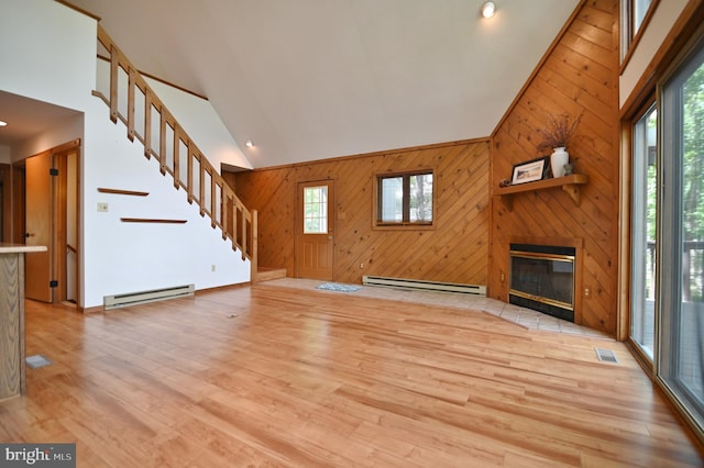 277 Anderson Rd, Basye, VA 22810 - unfurnished living room with a baseboard heating unit, high vaulted ceiling, stairs, wood walls, and wood finished floors