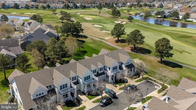 birds eye view of property featuring view of golf course, a residential view, and a water view