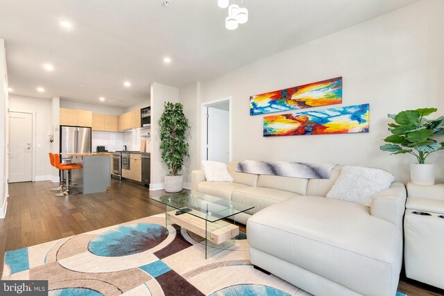 living area with baseboards, recessed lighting, and dark wood-style floors