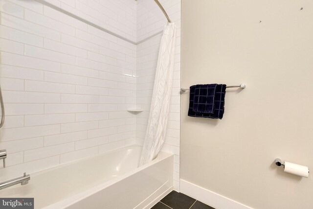 bathroom with baseboards, tile patterned flooring, and shower / bath combination with curtain