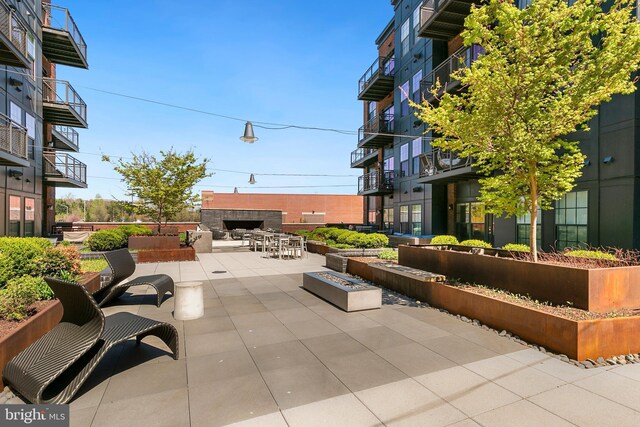 view of patio with exterior fireplace