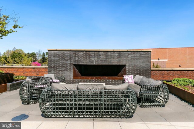 view of patio featuring an outdoor living space with a fireplace