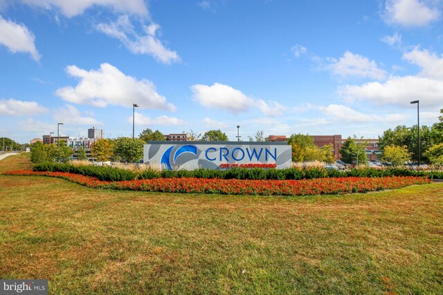 community sign featuring a lawn