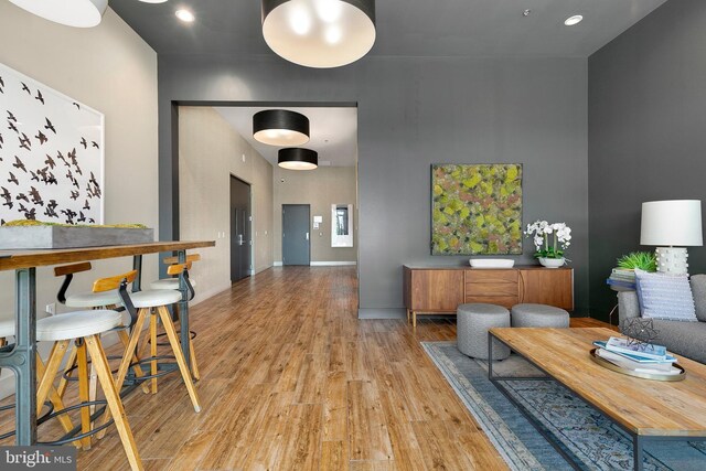 dining space with baseboards, recessed lighting, and light wood-style flooring
