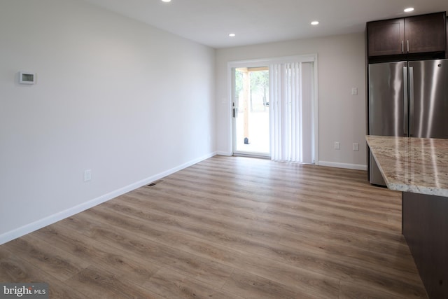 unfurnished living room with baseboards, visible vents, recessed lighting, and light wood-type flooring
