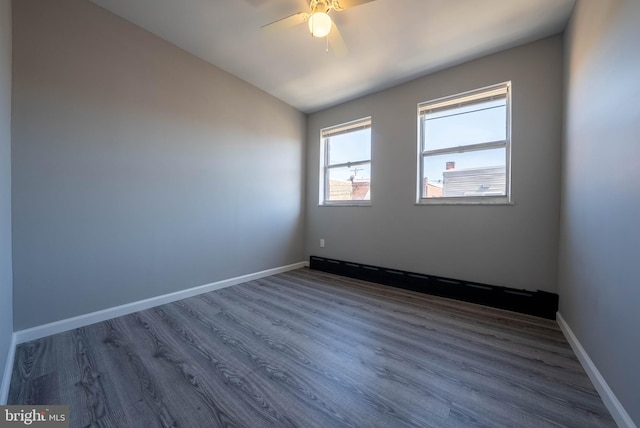 2105 S Woodstock St, Philadelphia, PA 19145 - unfurnished room featuring dark wood finished floors, baseboards, a ceiling fan, and vaulted ceiling