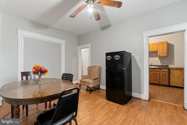 2609 Keyworth Ave, Baltimore, MD 21215 - dining area with light wood finished floors, ceiling fan, and baseboards
